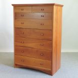 A modern cherrywood chest of drawers,