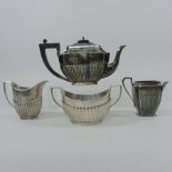 A Victorian silver teapot, of canted rectangular shape, with half gadrooned decoration,