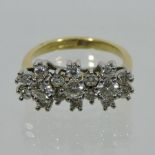An 18 carat gold triple cluster ring,