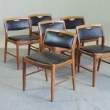 A set of six 1960's teak and black vinyl upholstered dining chairs