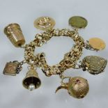 A 14 carat gold charm bracelet, suspended with eight various charms,