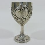 A Victorian silver presentation goblet, repousse decorated with flowers and scrolls,