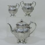 An Edwardian Scottish silver three piece bachelor's tea set, of circular shape,