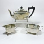 An Art Deco silver three piece tea service, comprising a teapot, 28cm, cream jug and sugar bowl,