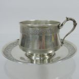 An early 20th century French silver cup and saucer,