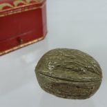 A Cartier 9 carat gold novelty snuff box, of hinged shape, in the form of a walnut, makers mark J.C.