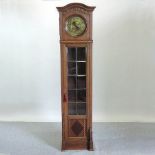 An early 20th century German oak cased longcase clock, with a brass dial, and bevelled glass door,