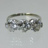 An 18 carat gold platinum set three stone diamond ring, each stone approx.