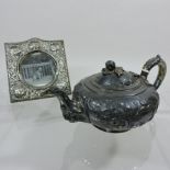 A George III silver teapot, of compressed circular shape, with a scrolled handle, London 1812,
