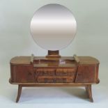 An Art Deco walnut dressing table, with a circular mirror,