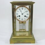 A late 19th century French brass cased four glass mantle clock,