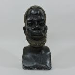 An African carved stone portrait bust of a tribesman,