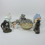 A Ronzan pottery model of a zebra, 18cm tall, together with another smaller,