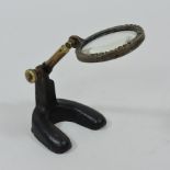 A Redfern magnifying glass, on an iron base,