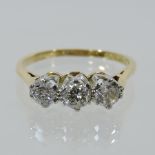 An 18 carat gold three stone diamond ring,