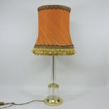 A large glass table lamp and shade, together with a coloured glass vase,