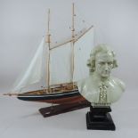 A model of a sailing ship, together with a decorative resin bust of Mozart,