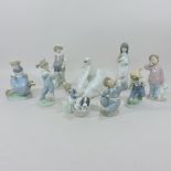 A Lladro model of a swan, together with eight Nao and Lladro figures,