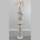 A Capodimonte style pottery figural standard lamp, with glass shades,