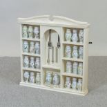 A cream painted spice cabinet, together with a set of Lenox porcelain spice jars,