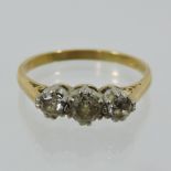 An 18 carat gold and diamond three stone ring