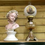 An early 20th century oil lamp, with a painted glass shade, together with a painted portrait bust,