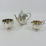 A continental silver three piece tea service, comprising of teapot, 12cm tall,
