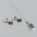 An 18 carat white gold, emerald and diamond earrings and pendant set,