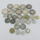 A collection of 50 franc coins and other francs