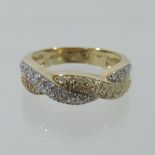 A 14 carat gold and diamond set crossover ring,