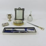 A collection of silver to include a photograph frame, trophy cup, a silver and enamelled card case,