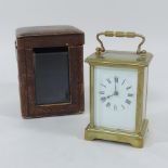 An early 20th century brass cased carriage clock, 14cm tall overall,