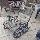 A cast iron and slatted hardwood garden rocking chair