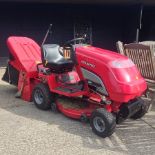 A red Countax C330 ride on petrol lawnmower,