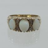 A 9 carat gold and opal three stone ring