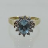 An 18 carat gold aquamarine and diamond cluster ring