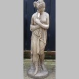 A reconstituted stone garden statue of a classical lady,