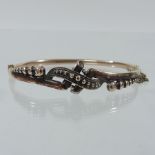 A Victorian hinged bangle, marked 9 carat,