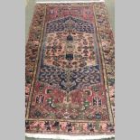 A Persian Tabriz rug, with geometric designs, on a purple ground,