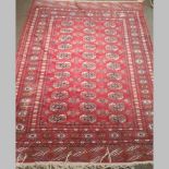A Bokhara rug, with all over medallions, on a red ground,