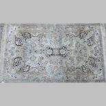 A Kashmir silk rug, with floral designs on a cream ground, 152 x 93cm,