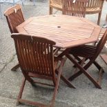 A teak octagonal garden table, 111cm, together with a set of four matching chairs,