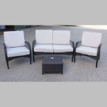 A rattan patio suite, comprising of a sofa, 125cm, two armchairs,