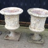 A pair of large reconstituted stone pedestal garden urns,