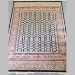 A Bokhara carpet, with all over designs on a blue ground,