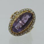 An 18 carat gold amethyst and seed pearl dress ring