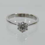 An 18 carat white gold solitaire diamond ring, boxed,