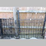 A collection of wrought iron black painted garden gates,