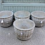 A set of four reconstituted stone planters,