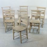 A set of seven elm seated chapel chairs